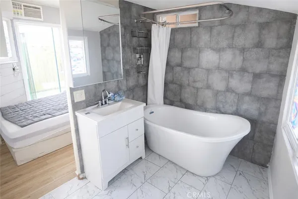 a white bath tub sitting next to a white sink