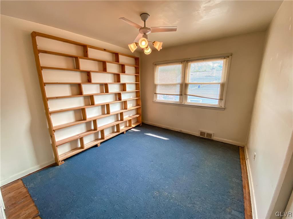 1934 Windsor Road Bethlehem, PA 18017 - Photo 16 of 32 an empty room with windows and chandelier fan