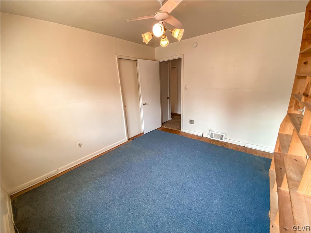1934 Windsor Road Bethlehem, PA 18017 - Photo 17 of 32 an empty room with a ceiling fan and a window