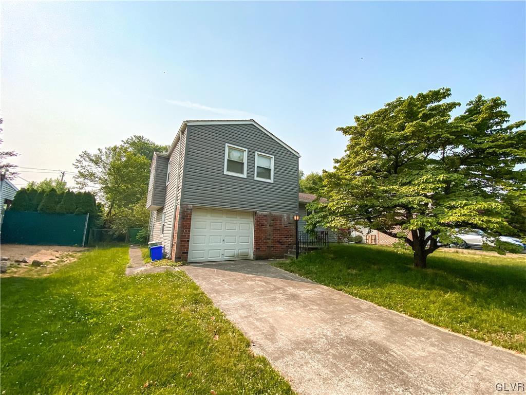1934 Windsor Road Bethlehem, PA 18017 - Photo 2 of 32 a front view of a house with a yard and garage