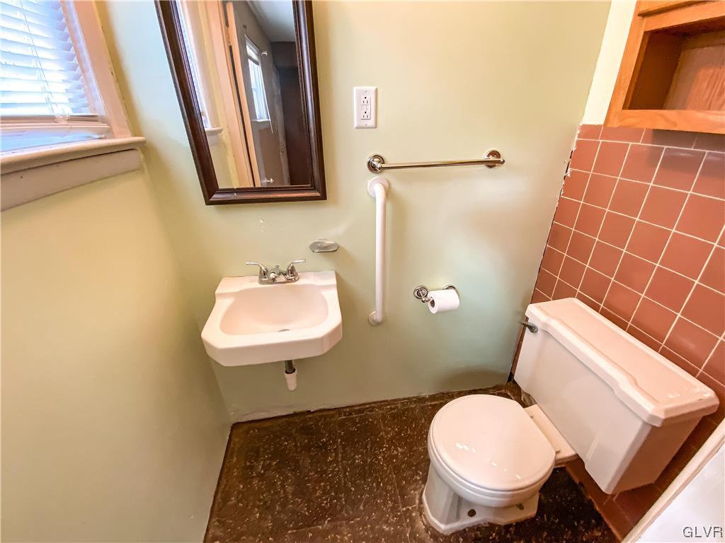 1934 Windsor Road Bethlehem, PA 18017 - Photo 21 of 32 a bathroom with a sink toilet and mirror