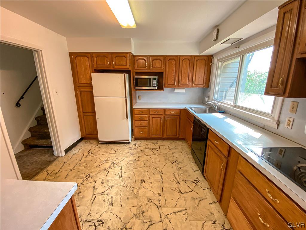1934 Windsor Road Bethlehem, PA 18017 - Photo 8 of 32 a kitchen with stainless steel appliances granite countertop a sink stove and refrigerator