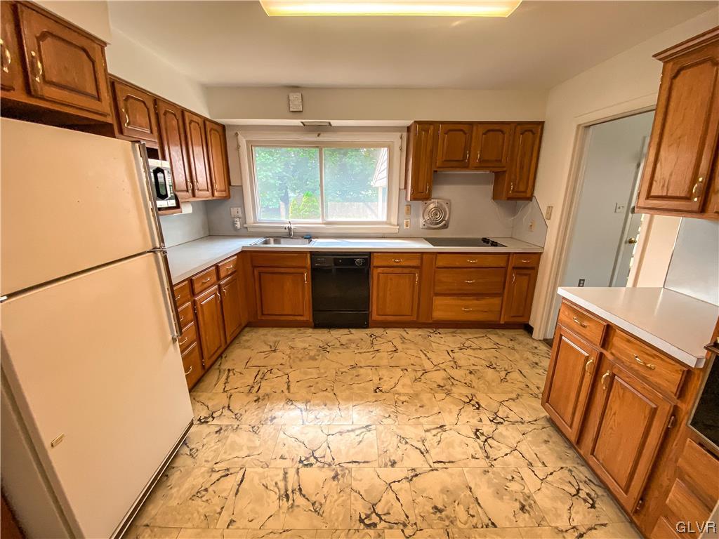 1934 Windsor Road Bethlehem, PA 18017 - Photo 9 of 32 a large kitchen with a sink a stove wooden floor and cabinets