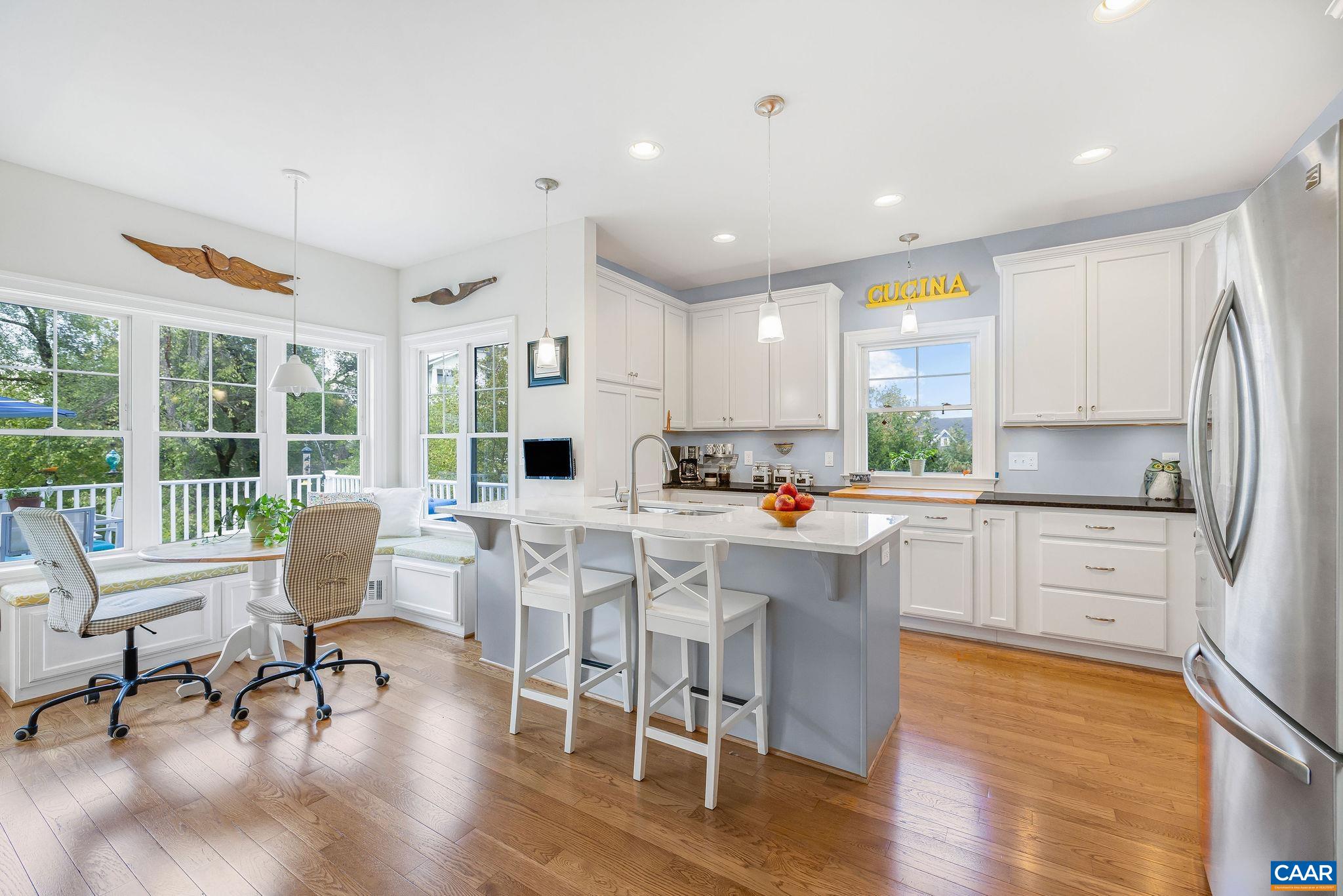 537 Trailside Drive Charlottesville, VA 22911 - Photo 17 of 52 a kitchen with stainless steel appliances granite countertop a stove a refrigerator a kitchen island and chairs in it