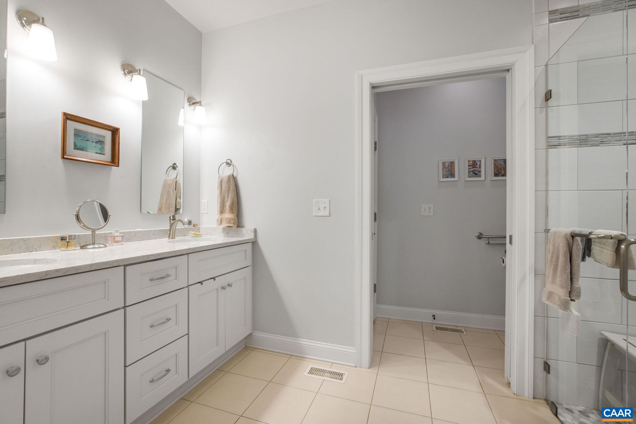 537 Trailside Drive Charlottesville, VA 22911 - Photo 22 of 52 a spacious bathroom with a double vanity sink a mirror and a shower