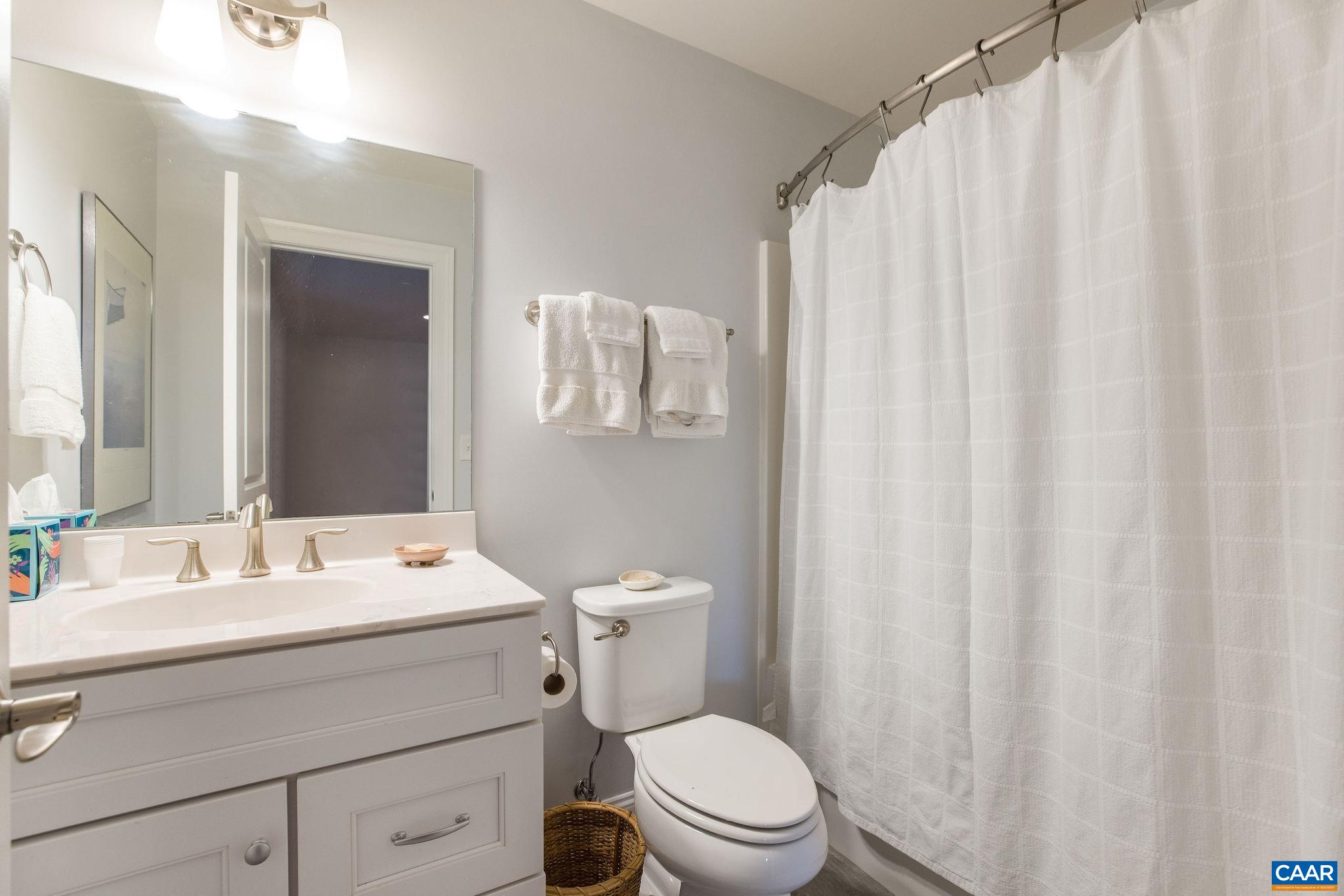 537 Trailside Drive Charlottesville, VA 22911 - Photo 32 of 52 a bathroom with a sink a toilet and shower curtain