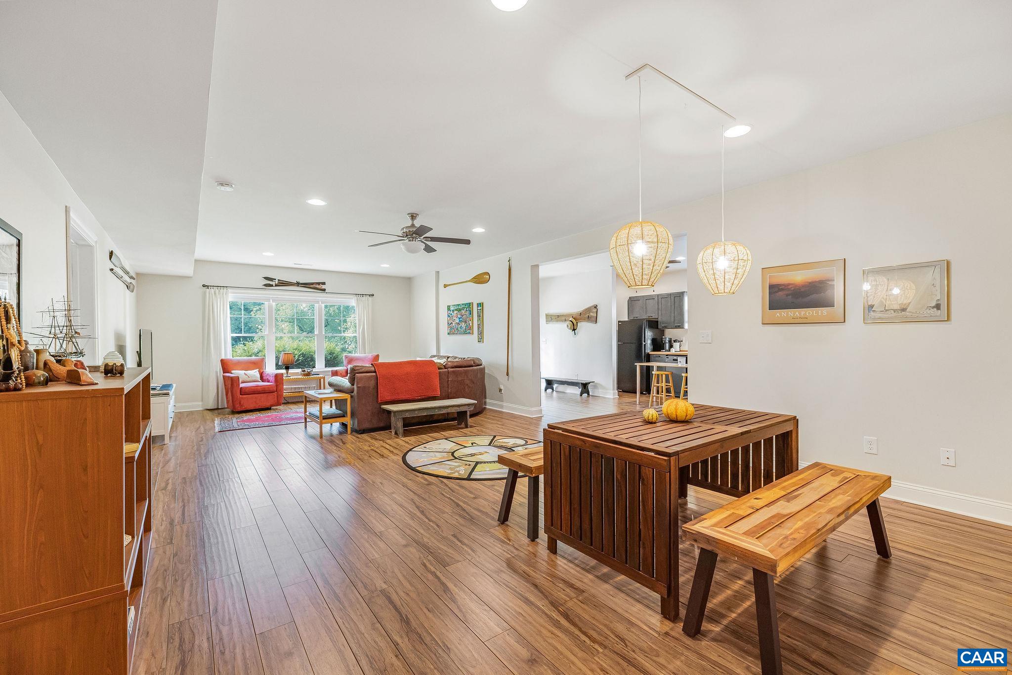 537 Trailside Drive Charlottesville, VA 22911 - Photo 36 of 52 a living room with furniture and a dining table with wooden floor