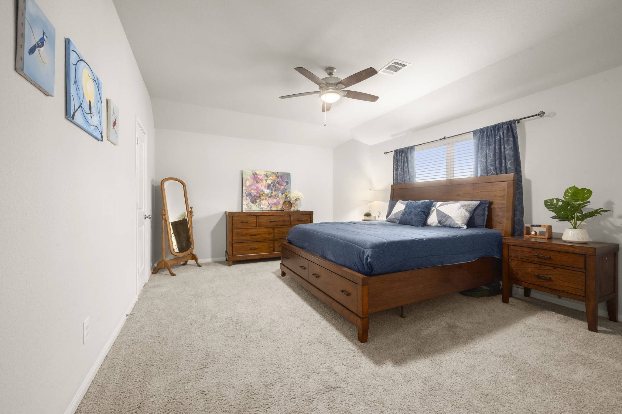 4915 Blue Jacaranda Way Spring, TX 77373 - Photo 15 of 30 Primary bedroom offers a neutral color palette, ceiling fan, plush carpet.