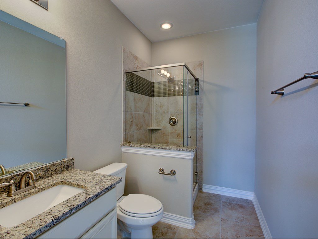 4303 Logan Ridge Drive Cedar Park, TX 78613 - Photo 17 of 24 Bathroom featuring a glass-enclosed shower with tile surround, a built-in shower niche, and recessed lighting