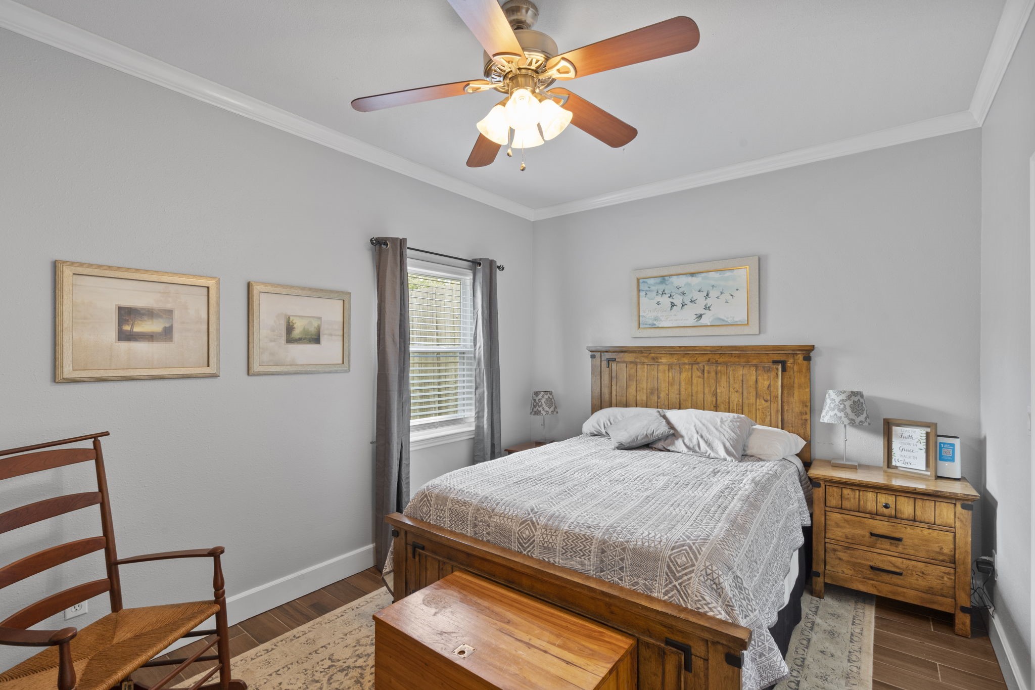 23200 Baneberry Road Magnolia, TX 77355 - Photo 18 of 39 a bedroom with a bed and a chandelier