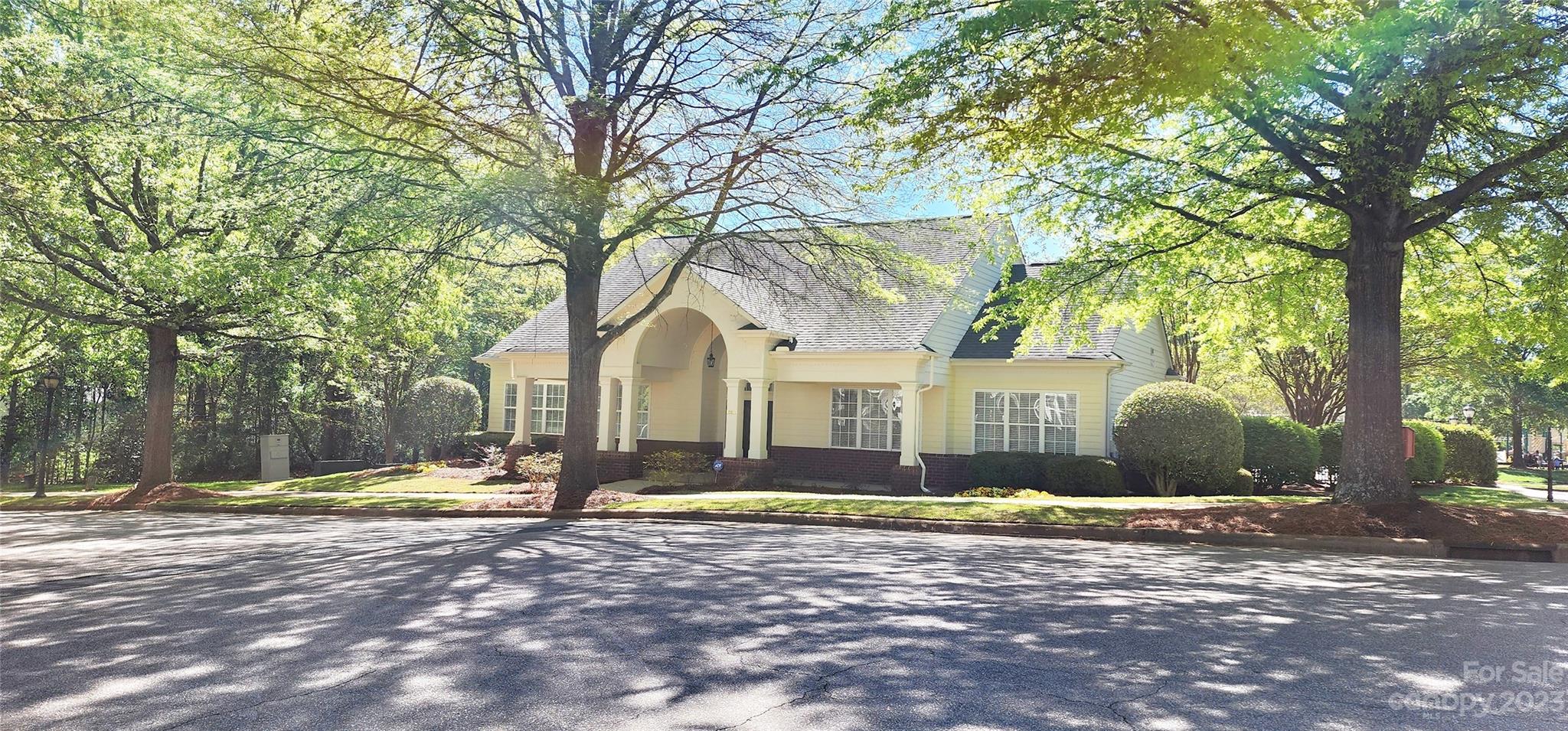 10125 Westmoreland Road, Unit 2D Cornelius, NC 28031 - Photo 12 of 36 a front view of a house with a yard and large trees