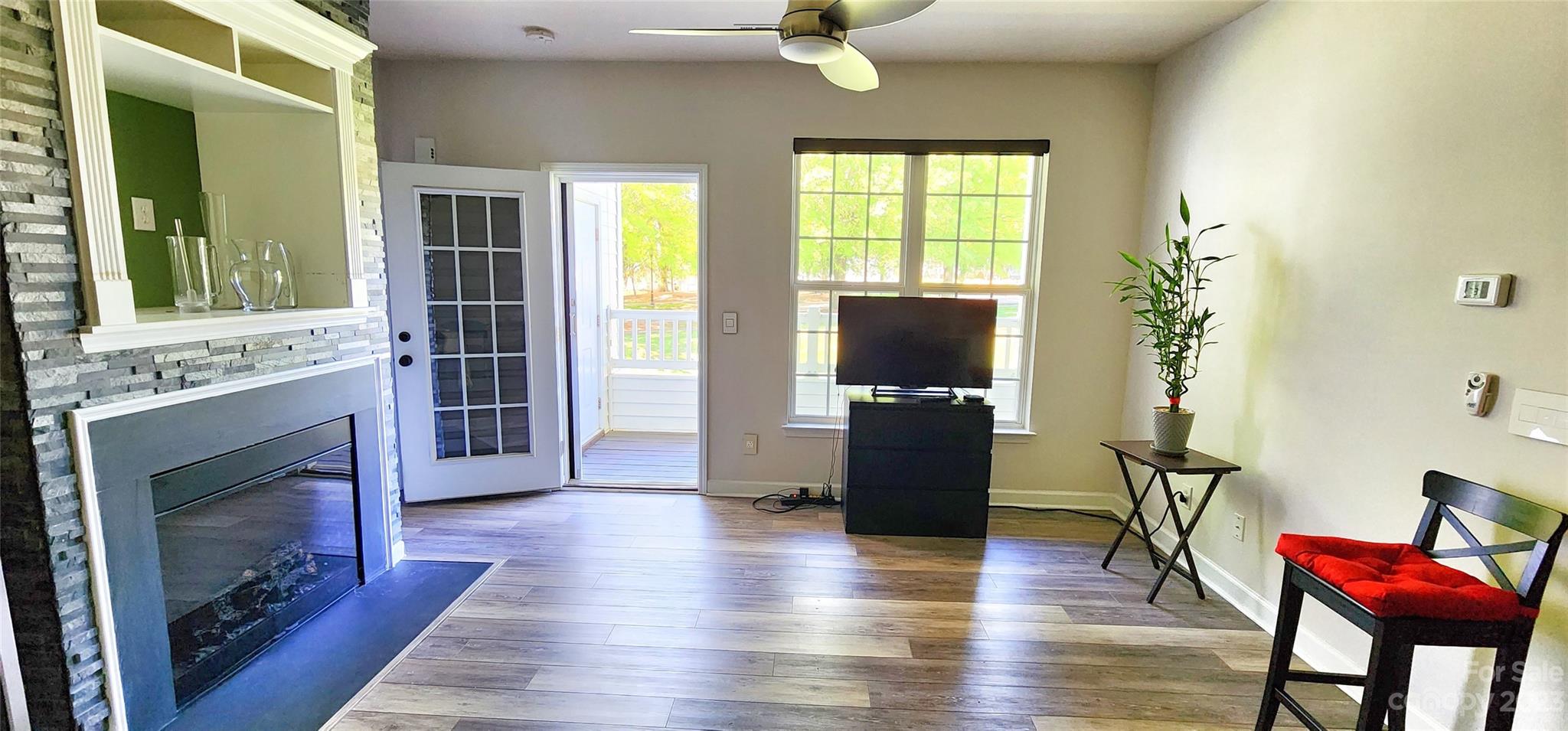 10125 Westmoreland Road, Unit 2D Cornelius, NC 28031 - Photo 21 of 36 a view of a livingroom with furniture a flat screen tv and wooden floor