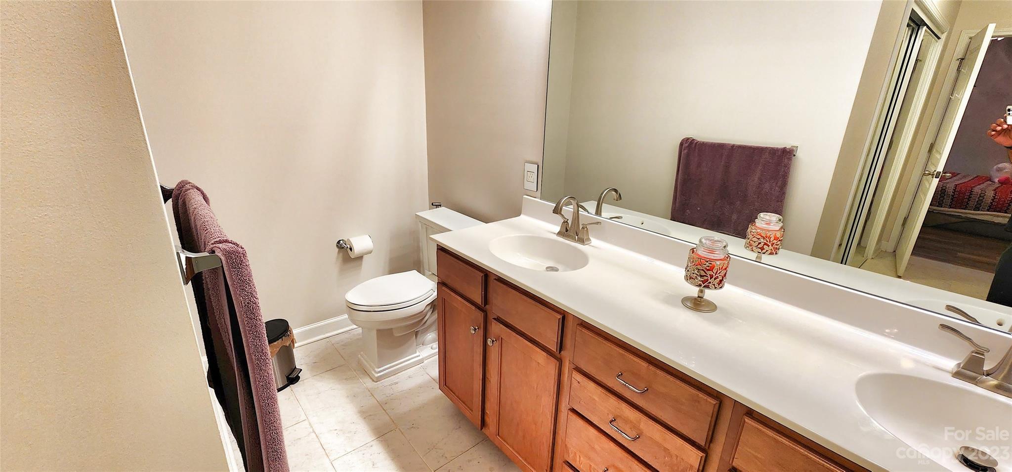 10125 Westmoreland Road, Unit 2D Cornelius, NC 28031 - Photo 35 of 36 a bathroom with a sink and a mirror