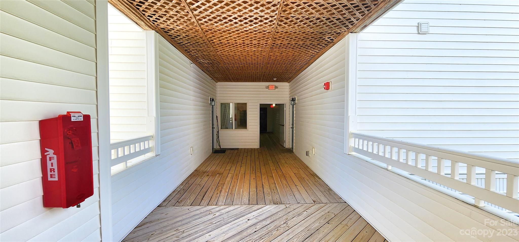 10125 Westmoreland Road, Unit 2D Cornelius, NC 28031 - Photo 10 of 36 a view of a balcony with wooden floor and stairs