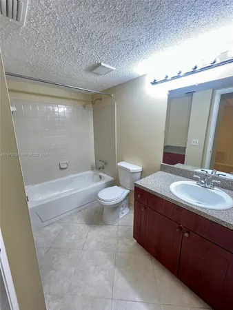 a bathroom with a double vanity sink toilet and shower