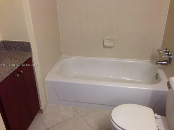 a bathroom with a sink a toilet and bathtub