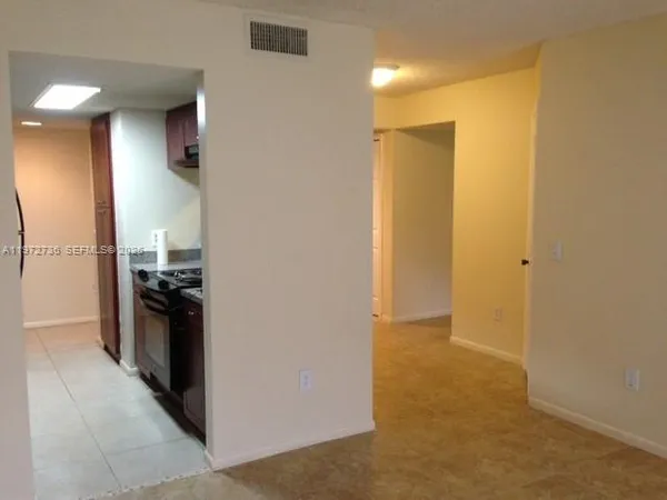 a view of a kitchen from the hallway