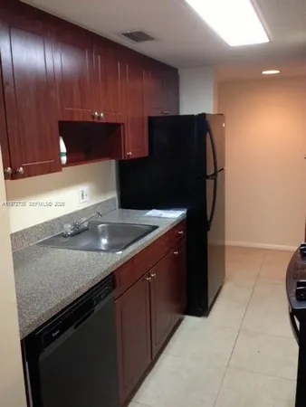 a kitchen with granite countertop stainless steel appliances and wooden cabinets
