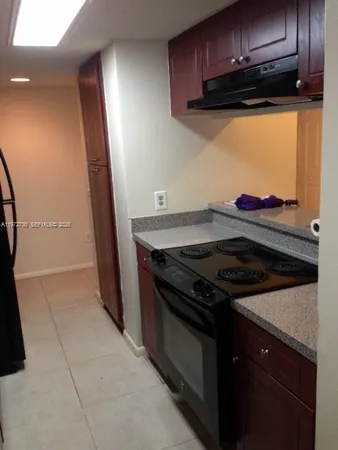 a stove top oven sitting inside of a kitchen