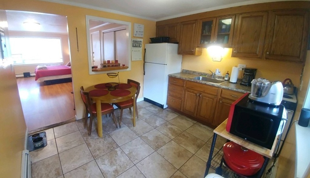 2 Colonial Drive, Unit 6 Andover, MA 01810 - Photo 2 of 12 a kitchen with stainless steel appliances granite countertop a refrigerator and a stove top oven