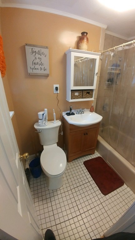2 Colonial Drive, Unit 6 Andover, MA 01810 - Photo 5 of 12 a bathroom with a toilet a sink and mirror