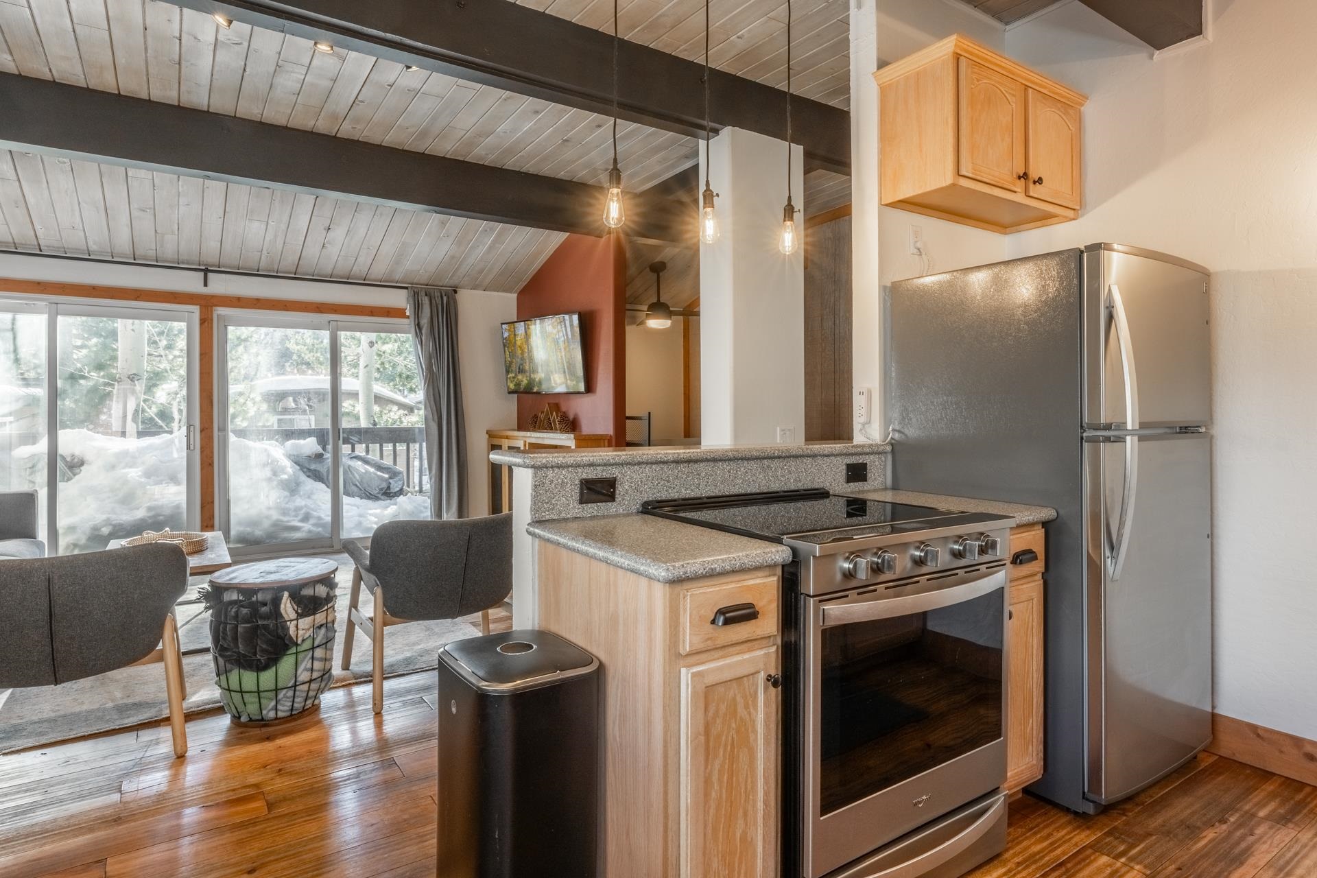 2290 Sierra Nevada Road, Unit 43 Mammoth Lakes, CA 93546 - Photo 15 of 33 a kitchen with stainless steel appliances granite countertop a stove a refrigerator and a fireplace