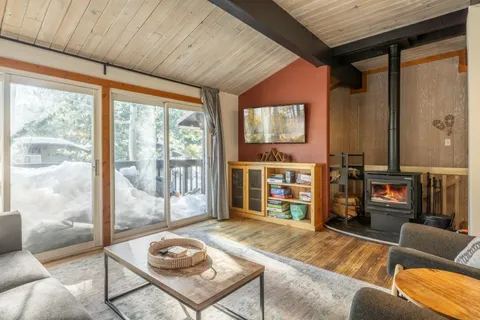 a living room with fireplace furniture and a flat screen tv