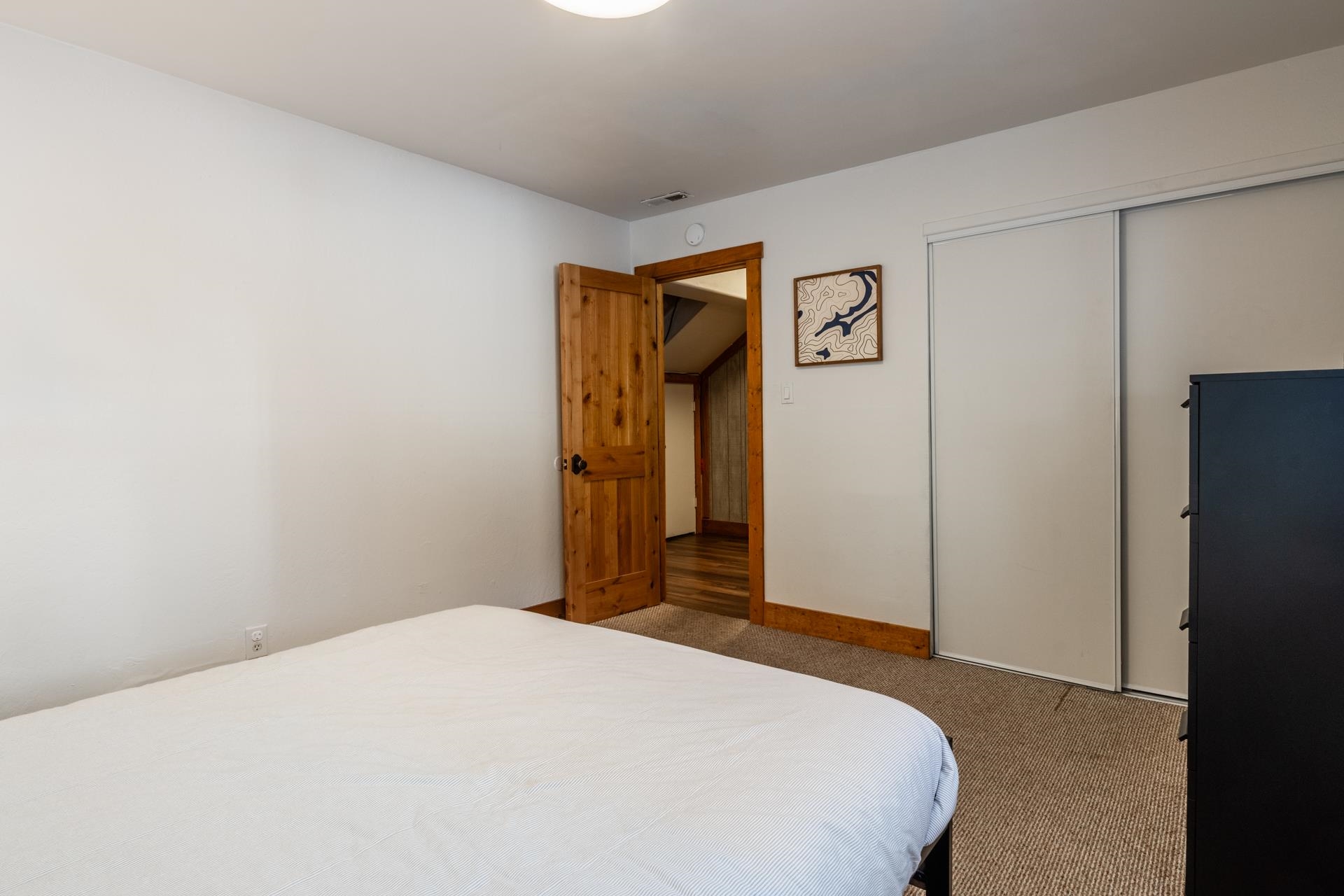 2290 Sierra Nevada Road, Unit 43 Mammoth Lakes, CA 93546 - Photo 22 of 33 a bedroom with a bed and a refrigerator