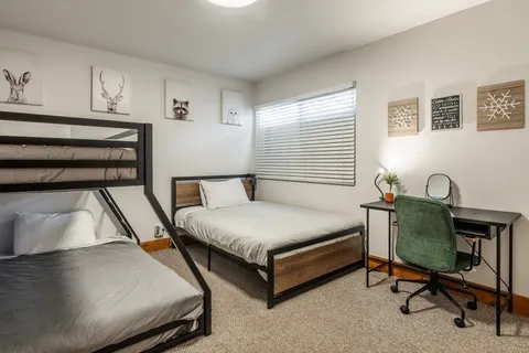 a bedroom with a bed chair and a window