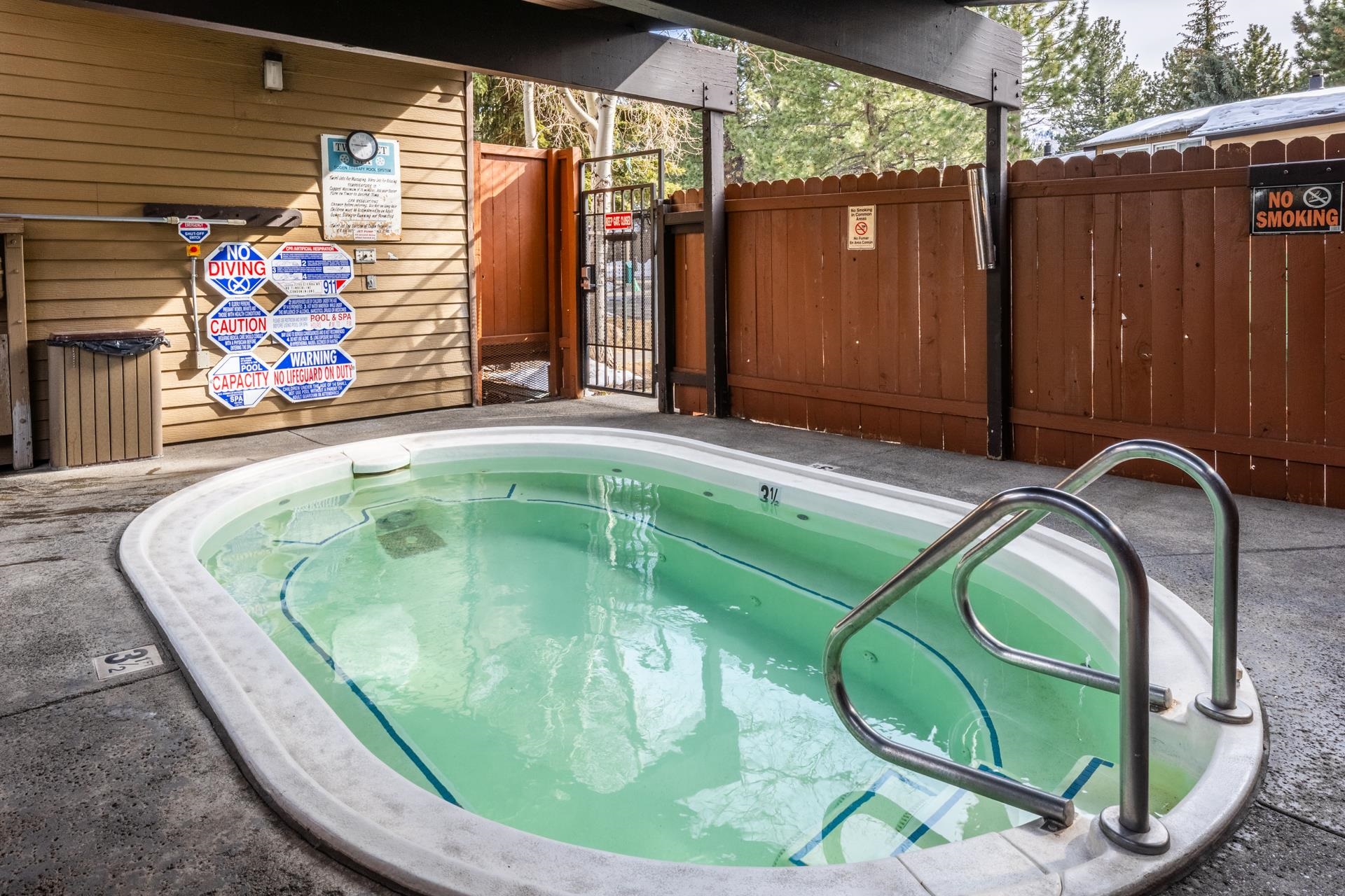 2290 Sierra Nevada Road, Unit 43 Mammoth Lakes, CA 93546 - Photo 31 of 33 a view of a wooden door with a chairs in a patio