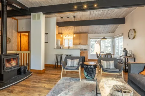 a dining room with furniture a fireplace and large window