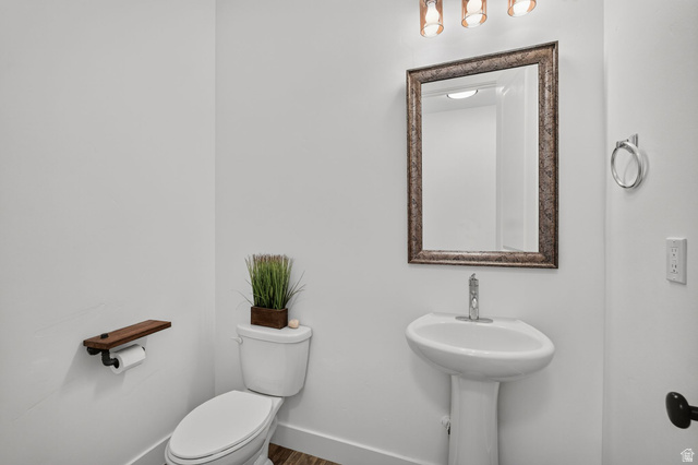 6536 West Muirfield Road Highland, UT 84003 - Photo 10 of 48 Pedestal sink with single-handle chrome faucet, framed mirror, and three-light vanity fixture