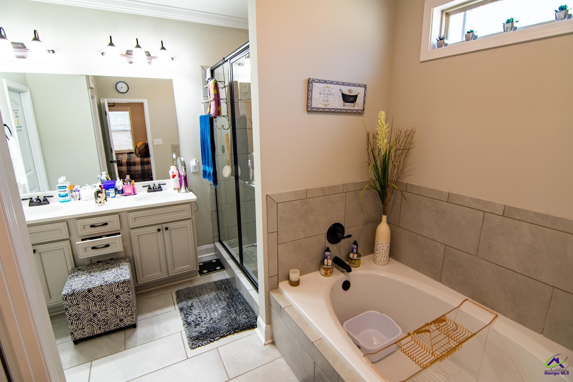 123 Logan's Mill Trail Warner Robins, GA 31093 - Photo 12 of 23 a bathroom with a tub sink and mirror