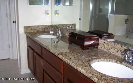 97285 Castle Ridge Drive Yulee, FL 32097 - Photo 14 of 23 a bathroom with a granite countertop sink and a mirror