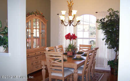 97285 Castle Ridge Drive Yulee, FL 32097 - Photo 2 of 23 a view of a dining room with furniture and chandelier