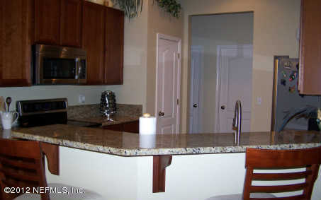 97285 Castle Ridge Drive Yulee, FL 32097 - Photo 3 of 23 a kitchen with granite countertop a sink and a stove top oven