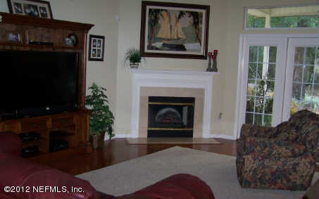 97285 Castle Ridge Drive Yulee, FL 32097 - Photo 8 of 23 a living room with furniture a flat screen tv and a fireplace