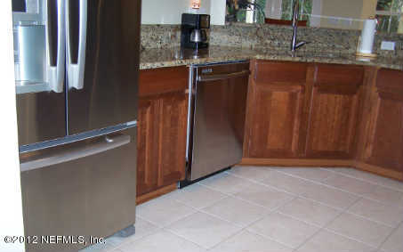 97285 Castle Ridge Drive Yulee, FL 32097 - Photo 9 of 23 a kitchen with stainless steel appliances granite countertop a refrigerator and a sink