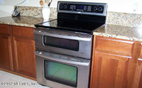 97285 Castle Ridge Drive Yulee, FL 32097 - Photo 10 of 23 a stove top oven sitting inside of a kitchen