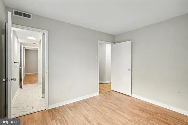 a view of an empty room with a closet