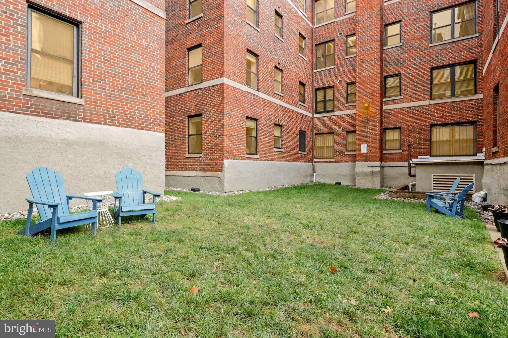 66 New York Avenue Northwest, Unit 206 Washington, DC 20001 - Photo 21 of 24 a brick building with a yard in front of it