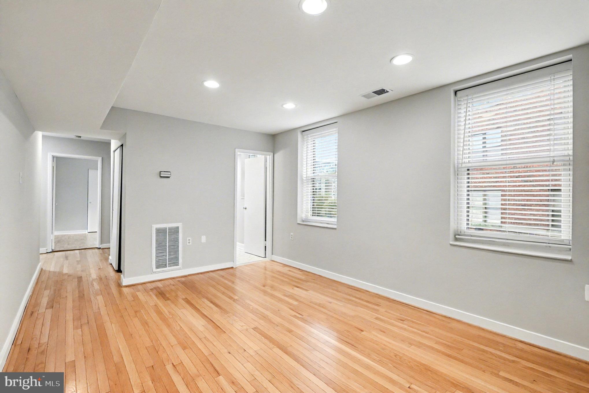 66 New York Avenue Northwest, Unit 206 Washington, DC 20001 - Photo 4 of 24 a view of empty room with wooden floor and fan