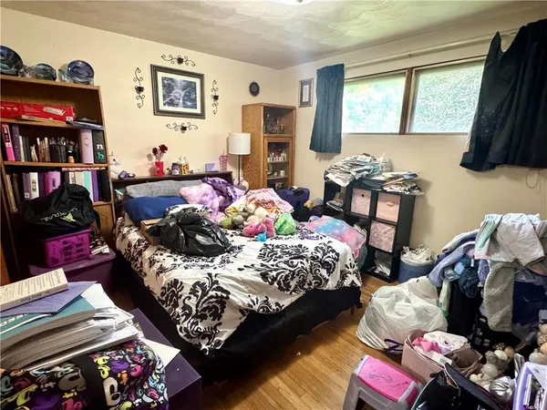 a bedroom with bed and a window