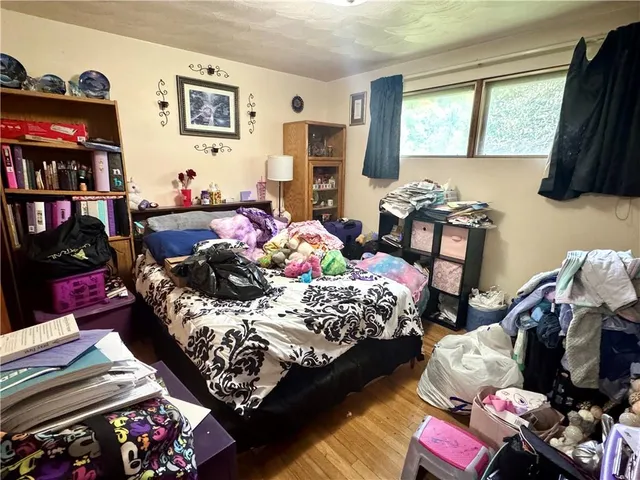 a bedroom with bed and a window