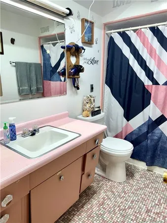 a bathroom with a sink toilet and shower