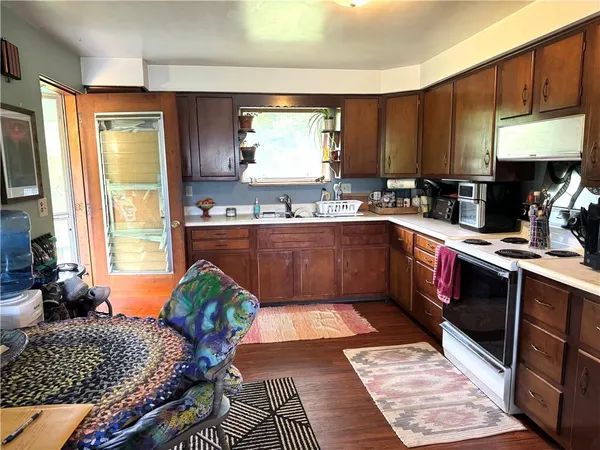 a kitchen with stainless steel appliances granite countertop sink stove and cabinets