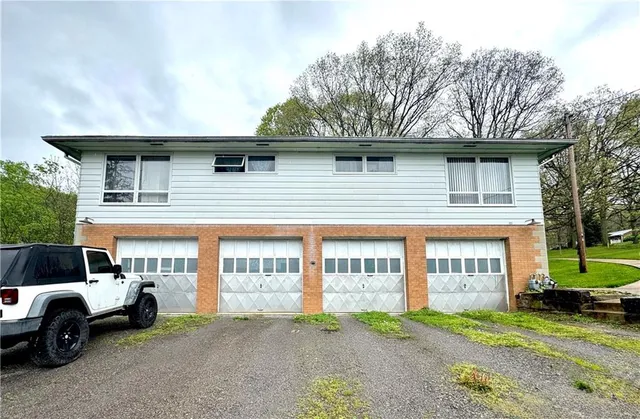 a view of a car park in front of a house