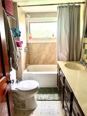 a bedroom with a bed dresser and a flat tv screen