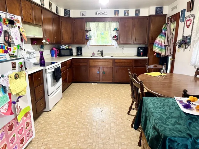 a kitchen with a sink appliances and cabinets