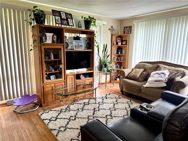 a living room with furniture and a book shelf